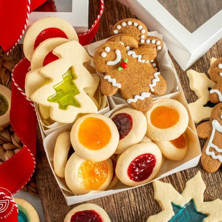gift box with windowpane cookies, gingerbread men, and thumbprint cookies
