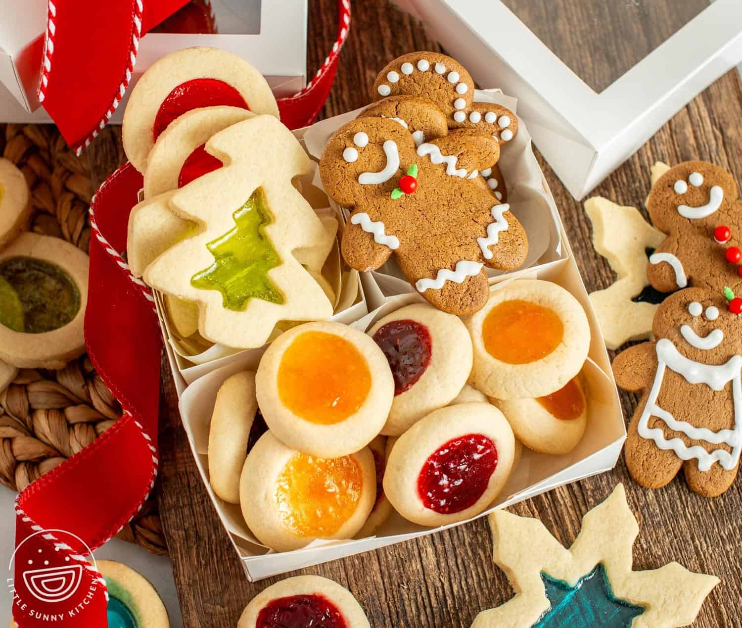 gift box with windowpane cookies, gingerbread men, and thumbprint cookies