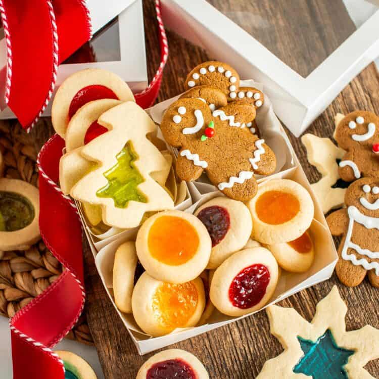 gift box with windowpane cookies, gingerbread men, and thumbprint cookies