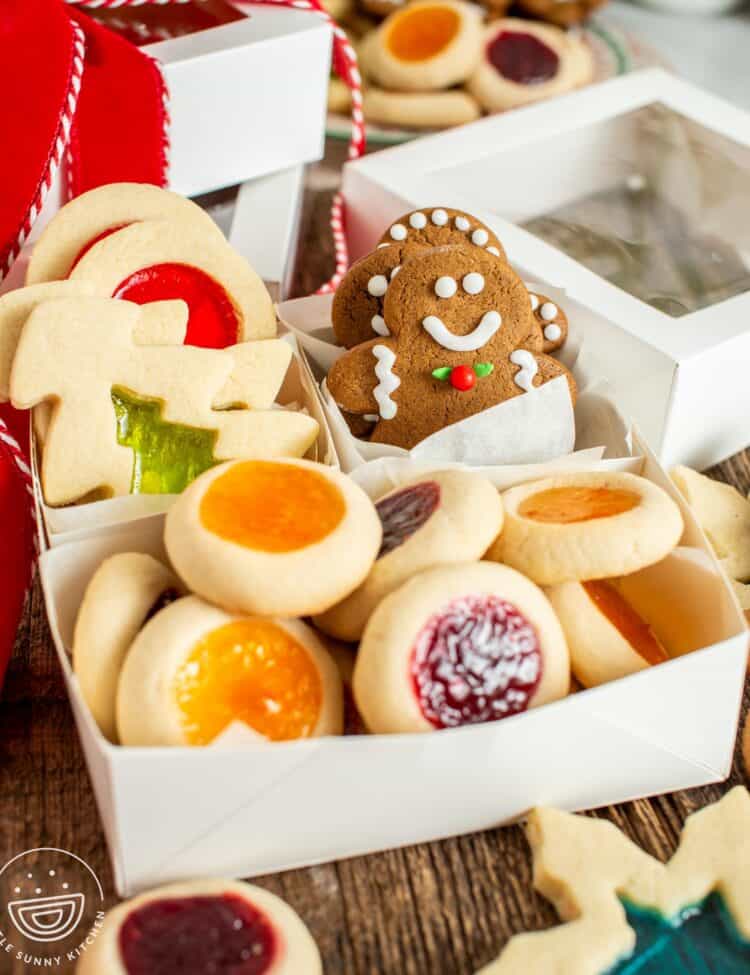 gift box with windowpane cookies, gingerbread men, and thumbprint cookies