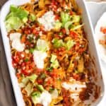overhead view of a 9x13-inch white casserole dish filled with Frito Pie.