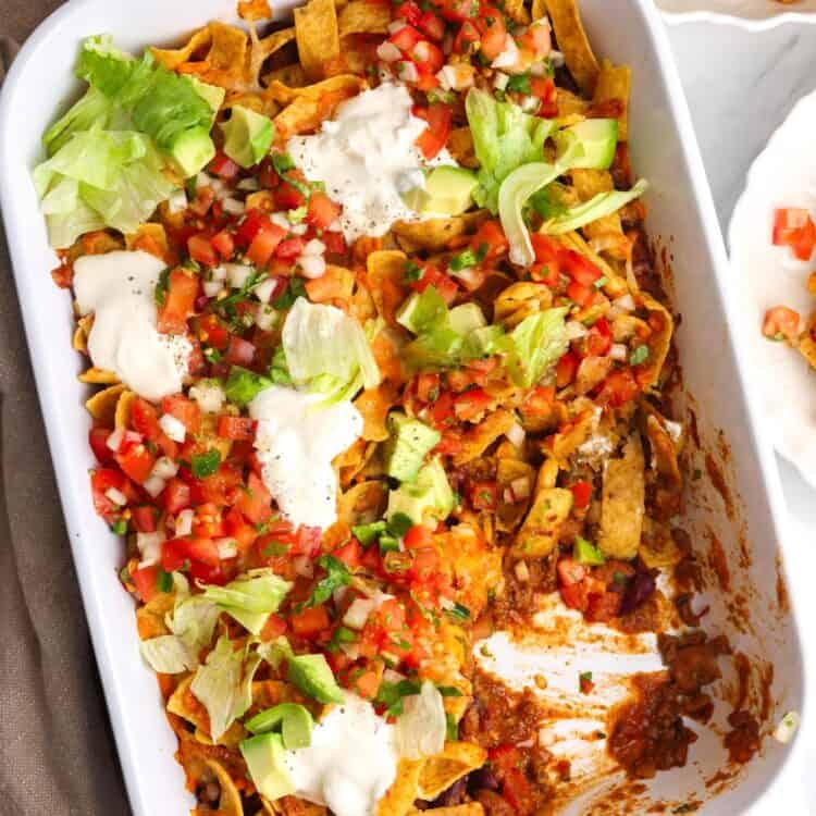 overhead view of a 9x13-inch white casserole dish filled with Frito Pie.