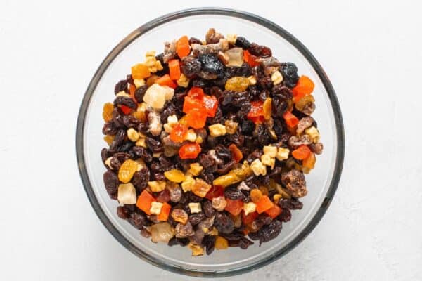 Mixed dried fruit in a glass bowl.