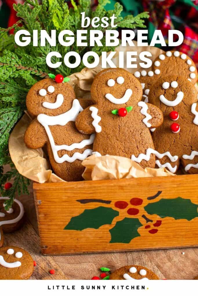 smiling gingerbread men cookies arranged in a holiday wooden box.