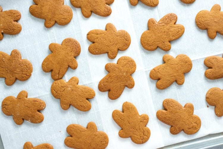 baked gingerbread men on parchment paper.
