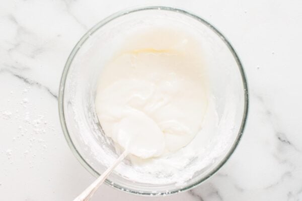icing for gingerbread cookies mixed in a glass mixing bowl.
