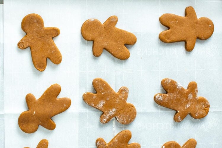 gingerbread men cutout cookies on parchment paper.