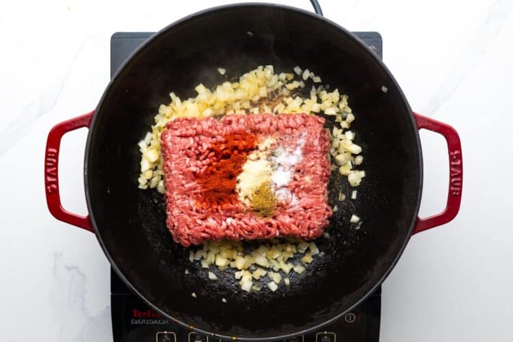ground beef and seasonings in a large skillet with sauteed onions.