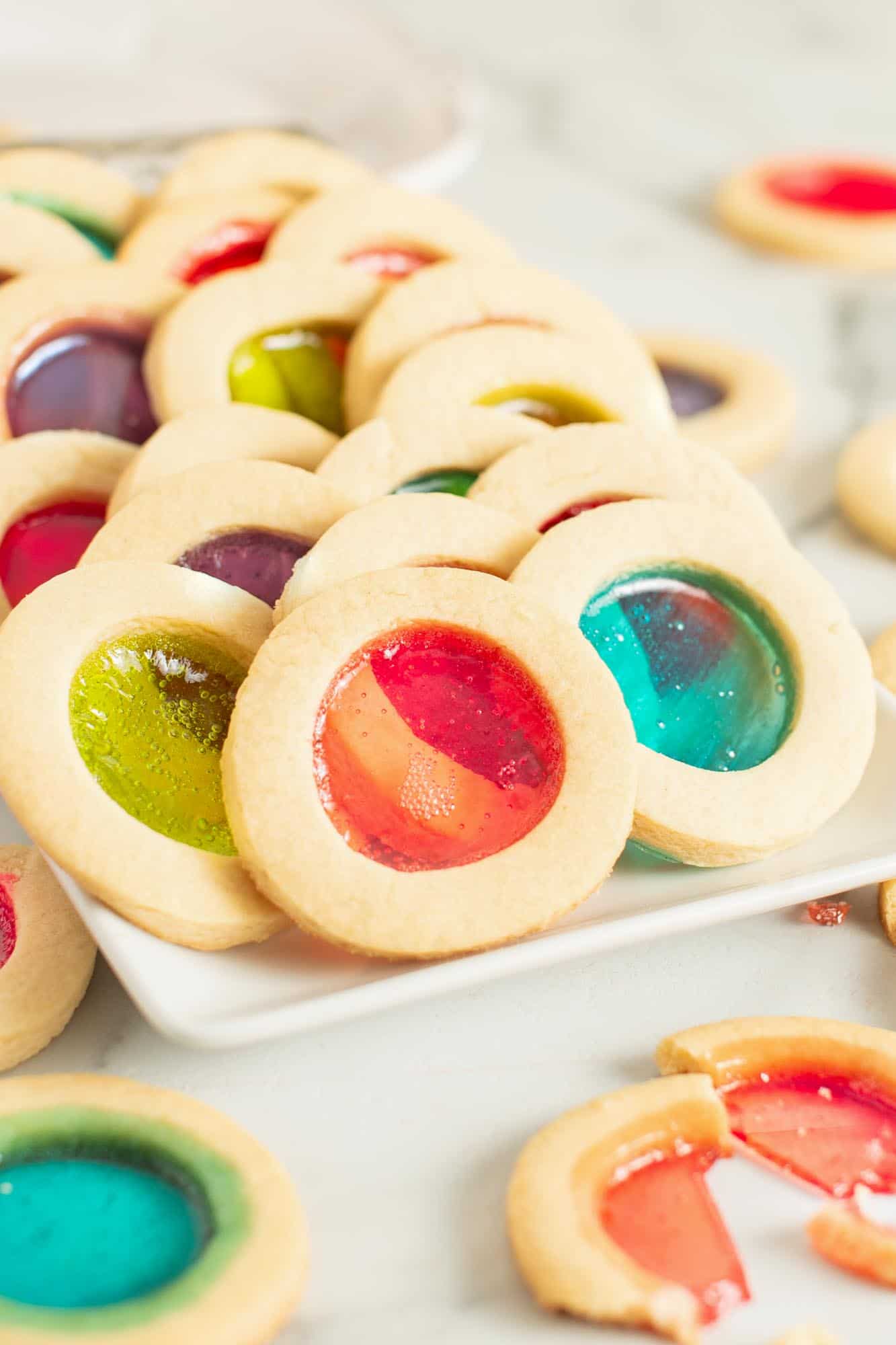 a platter of round stained glass cookies in bright colors.
