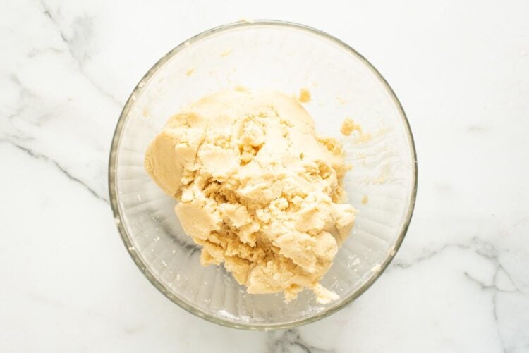 sugar cookie dough mixed in a large glass bowl.