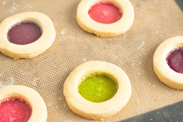 stained glass cookies that have been baked on a silpat mat.