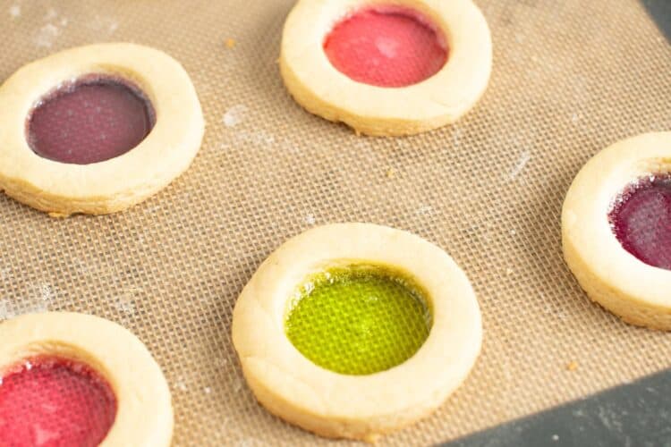 stained glass cookies that have been baked on a silpat mat.