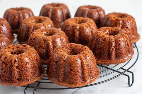 small mini bundt sticky toffee pudding cakes on a wire rack.