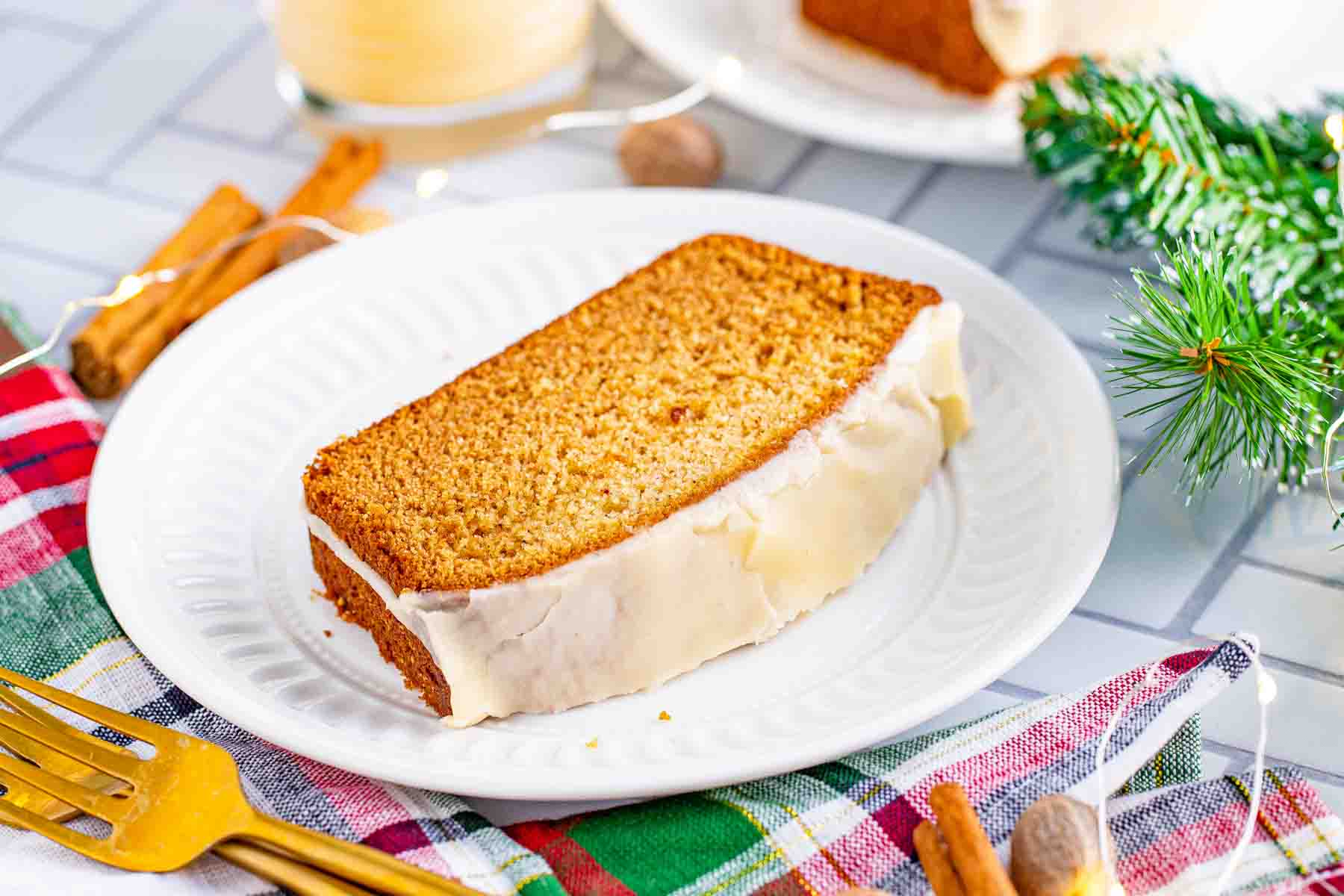 A slice of eggnog bread served on a white plate