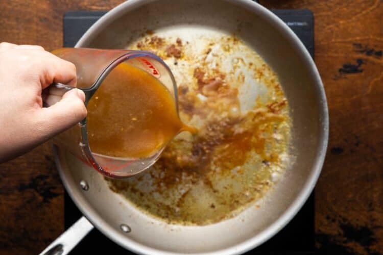 orange juice mixed with soy sauce and seasonings, poured into a skillet to make a sauce.
