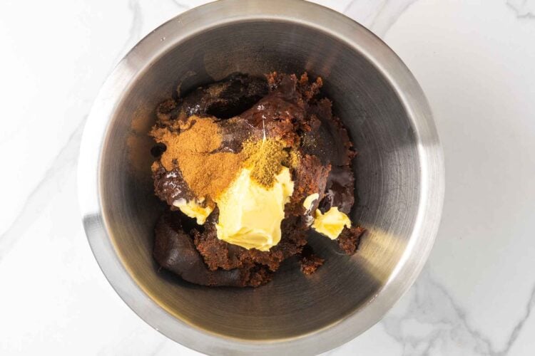 Date paste mixed with butter and spices in a bowl before blending into a smooth filling.