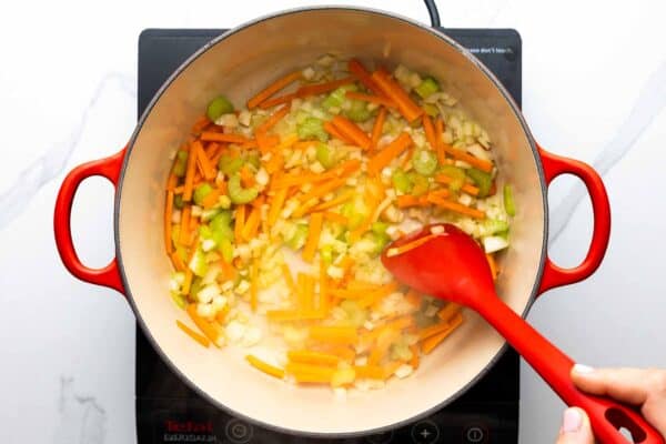 chopped carrots, onion, and celery, cooked in a dutch oven for soup.