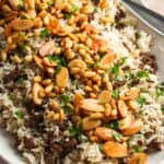 A large platter of Lebanese hashweh topped with toasted nuts