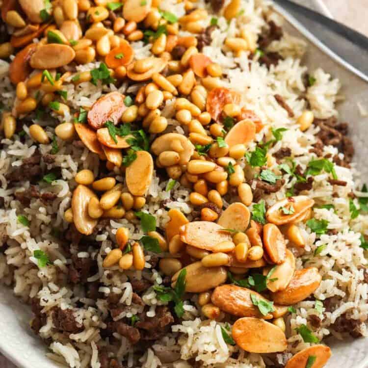 A large platter of Lebanese hashweh topped with toasted nuts