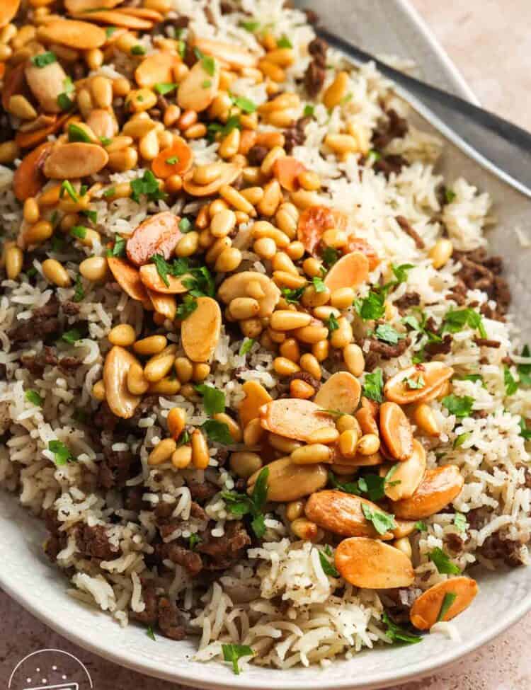 A large platter of Lebanese hashweh topped with toasted nuts