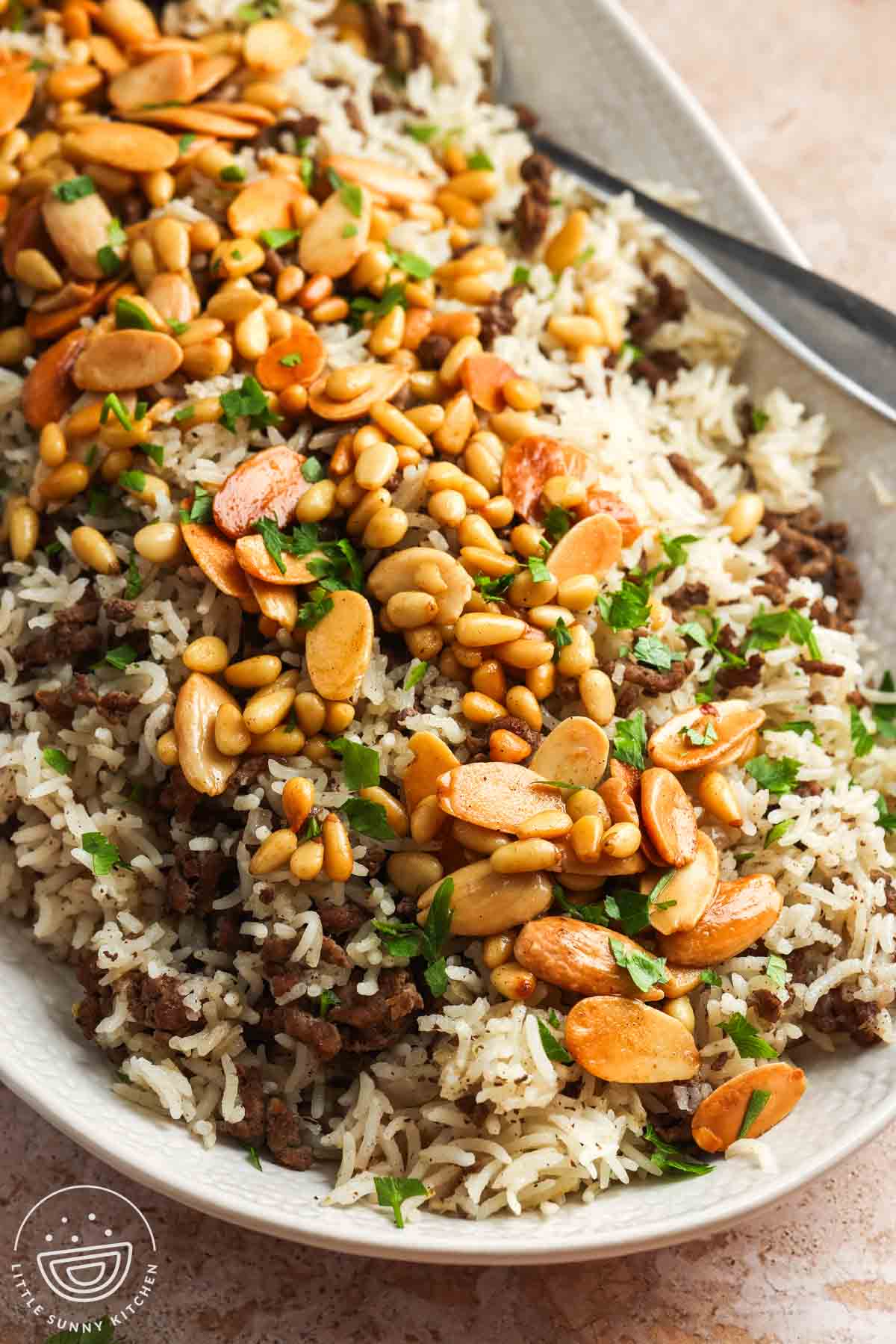 A large platter of Lebanese hashweh topped with toasted nuts