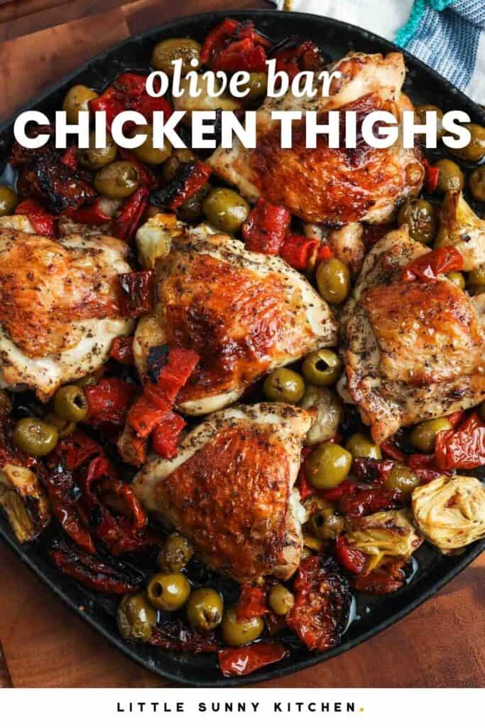 Crispy bone in chicken thighs baked with olives and red peppers, on a black rectangular platter. Text overlay says "olive bar chicken thighs"