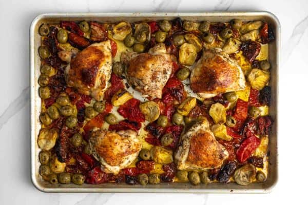 baked olive bar chicken thighs on a sheet pan.