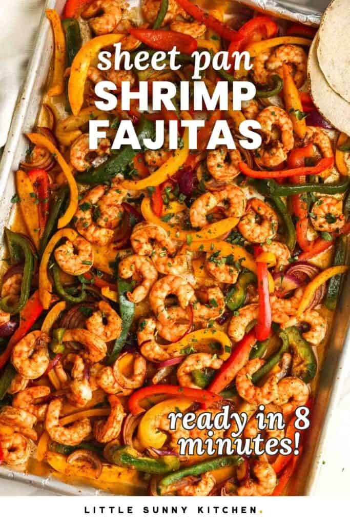 Cooked shrimp with colorful peppers and onions on a sheet pan. Text overlay says "sheet pan shrimp fajitas" and "ready in 8 minutes!"
