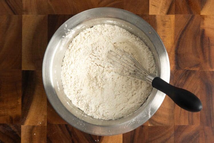 dry ingredients for banana bread, whisked in a metal mixing bowl.
