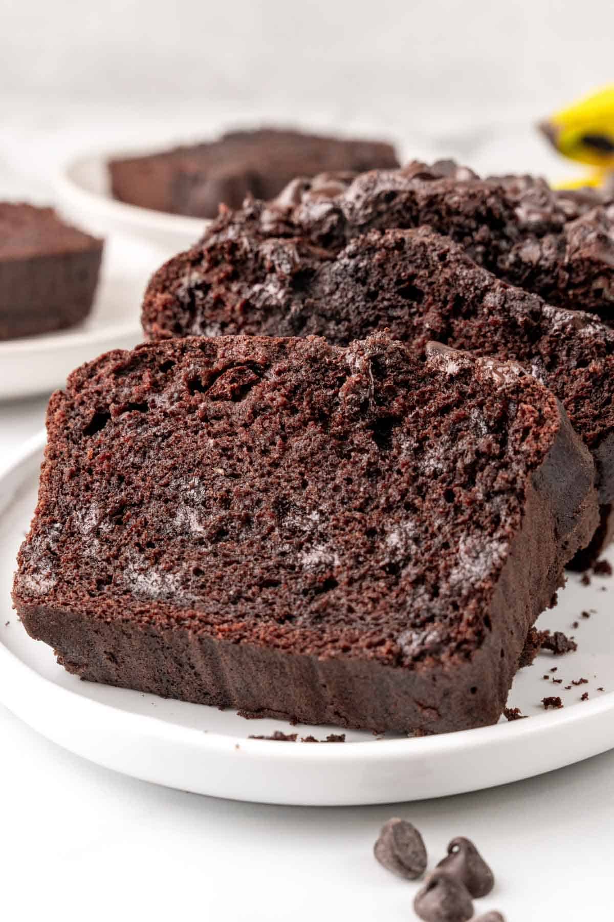 Slices of chocolate chip chocolate banana bread on a white plate.