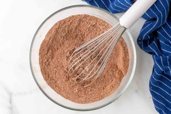 cocoa powder and flour whisked in a glass mixing bowl.