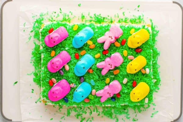 Decorated Easter sugar cookie bars topped with Peeps and jelly beans before slicing.