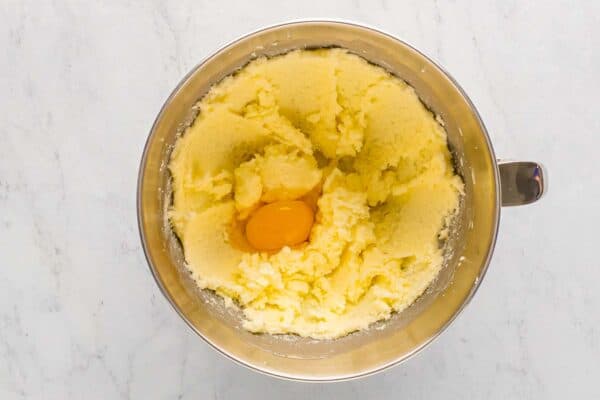 Butter and sugar creamed together in a mixing bowl with one egg added.
