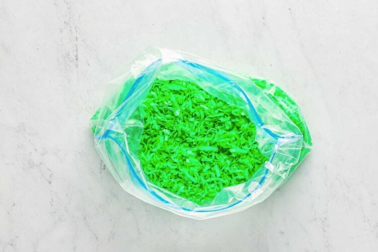 Coconut flakes dyed green inside a zip top bag.