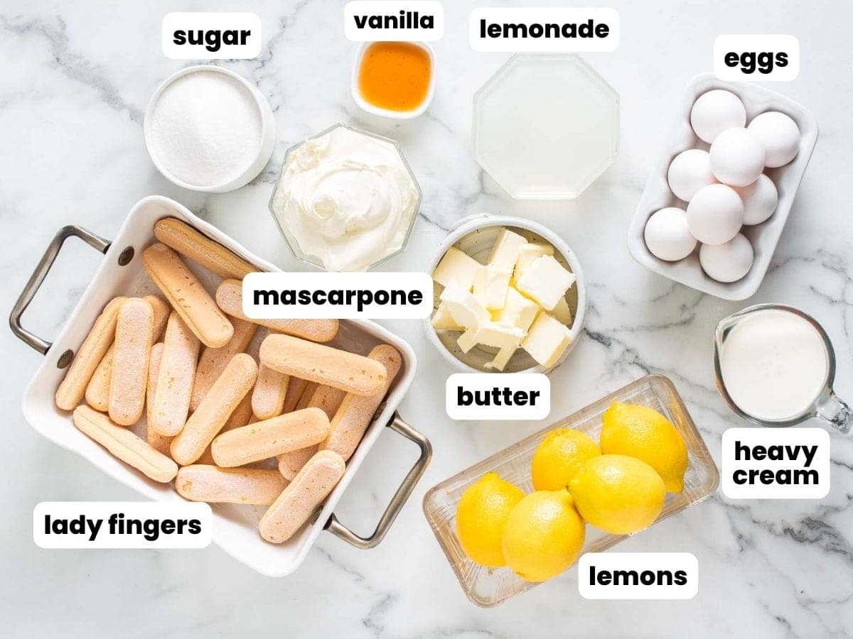 Ingredients for lemon tiramisu including mascarpone, lemon curd, ladyfingers, sugar, lemons, and cream.