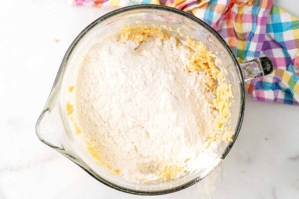 flour mixture added to butter mixture for easter cookie dough