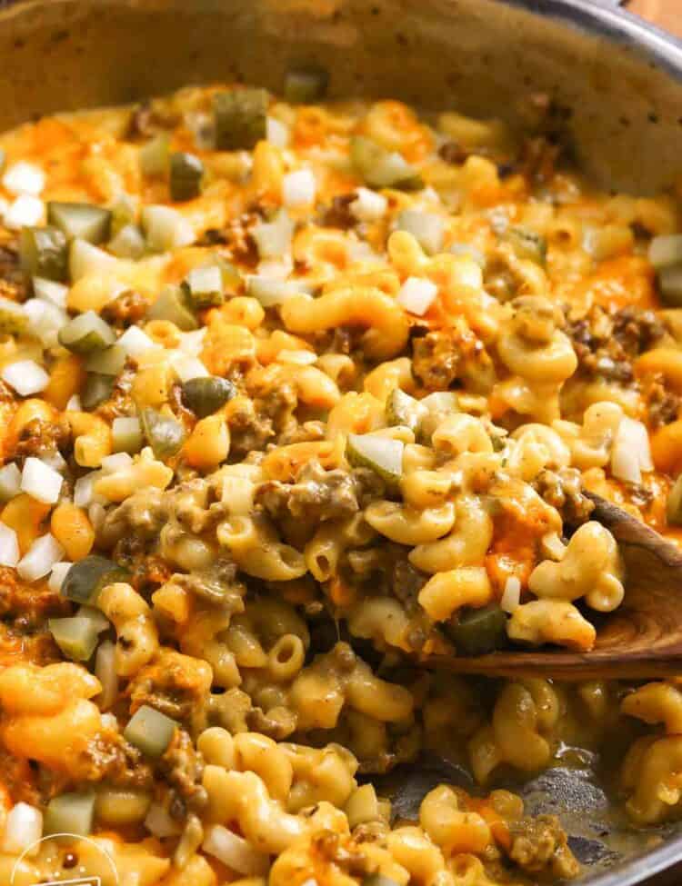 Cheeseburger mac and cheese, finished with chopped dill pickles and chopped raw onion.