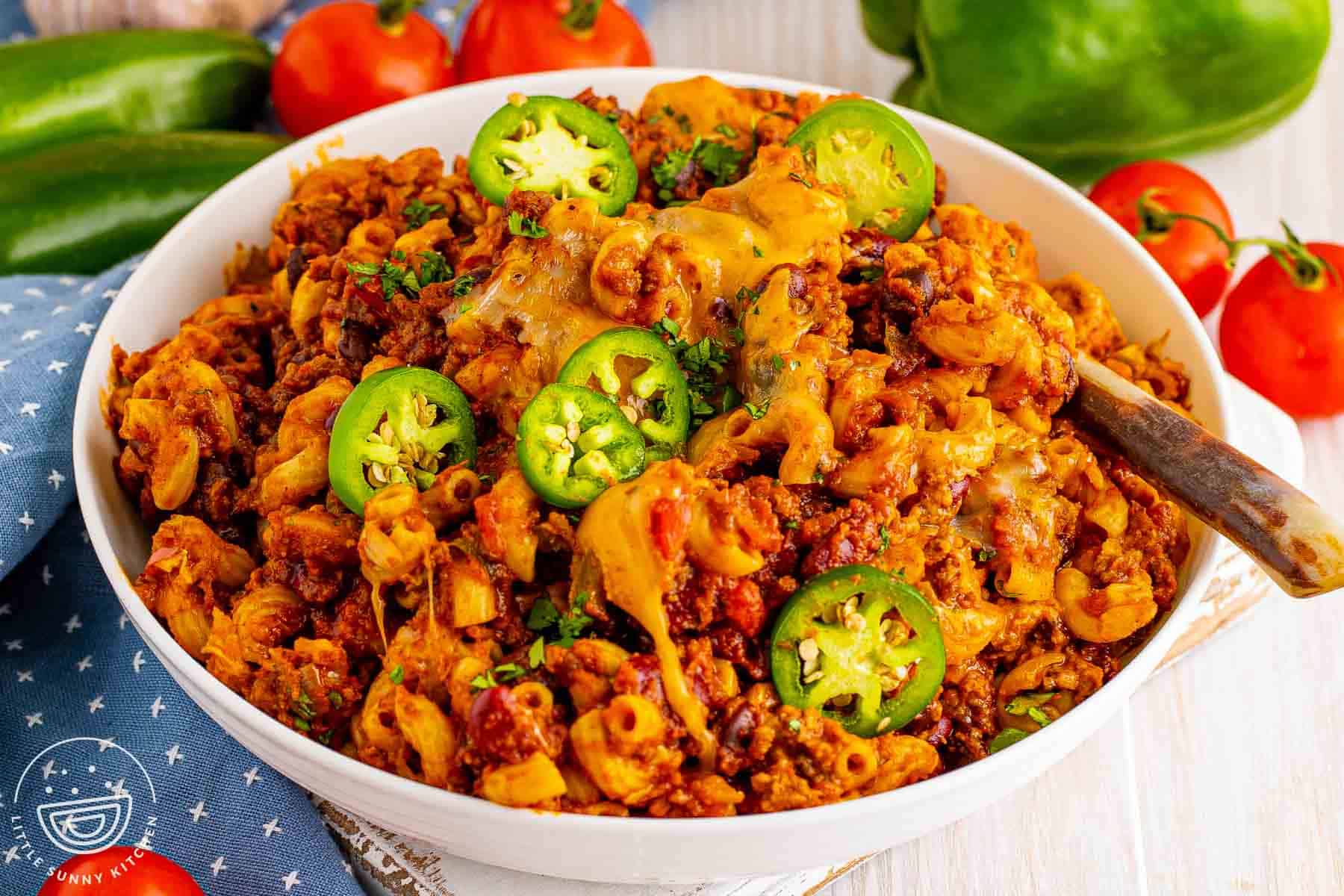 Bowl of chili macaroni with melted cheese, jalapeños, beef, beans, and elbow pasta