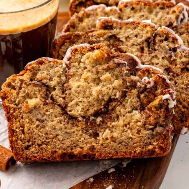 closeup of slices of cinnamon swirl banana bread, showing the moist, fluffy crumb and cinnamon sugar interior.