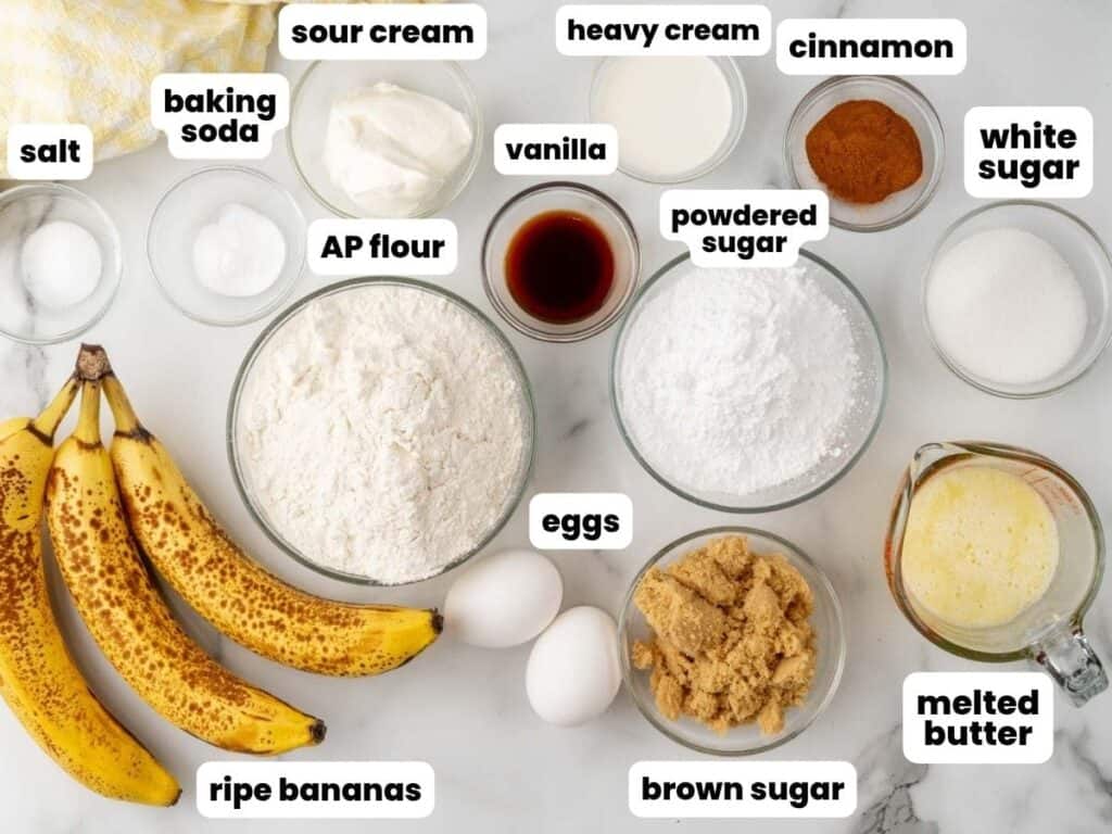 ingredients for making banana bread with a cinnamon sugar swirl, measured into small glass bowls and arranged on a counter, viewed from overhead.