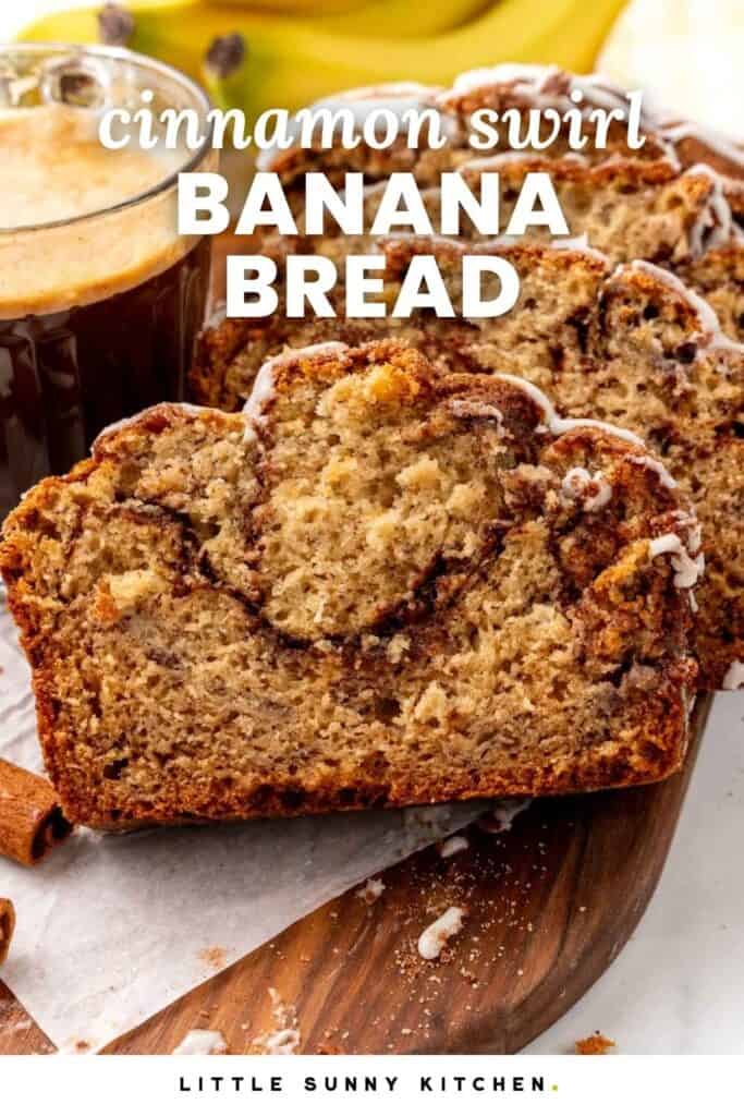 slices of banana bread on a wooden board next to a cup of coffee and in front of a bunch of bananas. Text overlay says "cinnamon swirl banana bread"