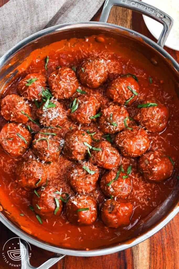 meatballs made with ricotta cheese, finished in a skillet with marinara sauce, topped with parmesan cheese and chiffonade basil.