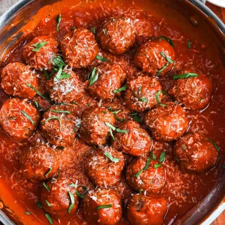 meatballs made with ricotta cheese, finished in a skillet with marinara sauce, topped with parmesan cheese and chiffonade basil.