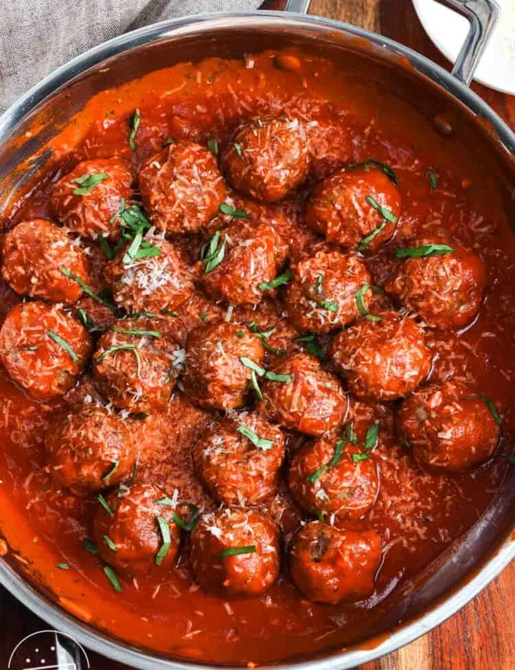 meatballs made with ricotta cheese, finished in a skillet with marinara sauce, topped with parmesan cheese and chiffonade basil.