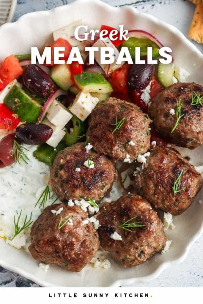 a bowl of Greek olives with dill sauce and greek salad. Text overlay says "Greek Meatballs"