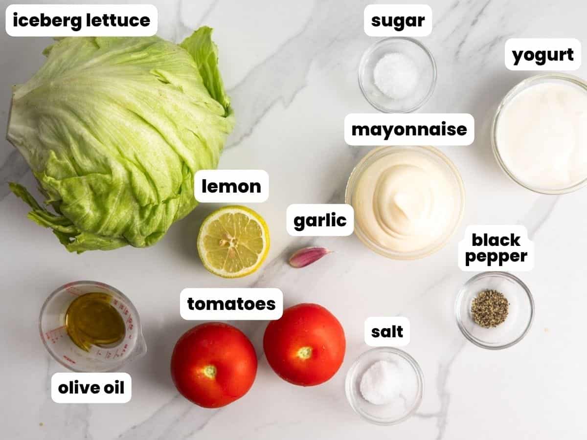 Ingredients for the sides for Halal cart chicken bowls, including lettuce, tomatoes, and yogurt and mayo to make a creamy sauce.