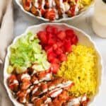 overhead view of two homemade halal cart rice bowls with chicken.