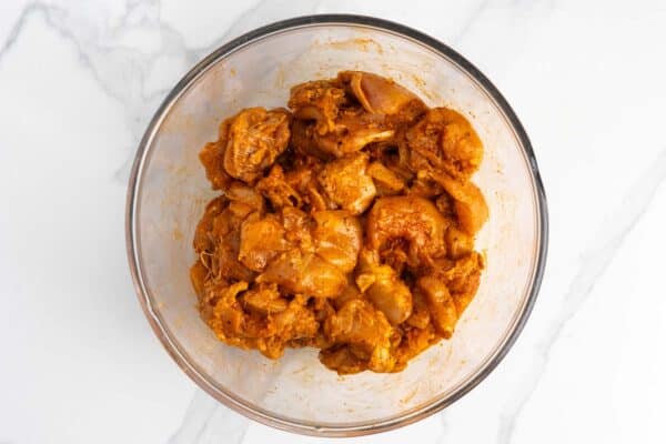 cubes of chicken marinated in spices for halal chicken bowls.