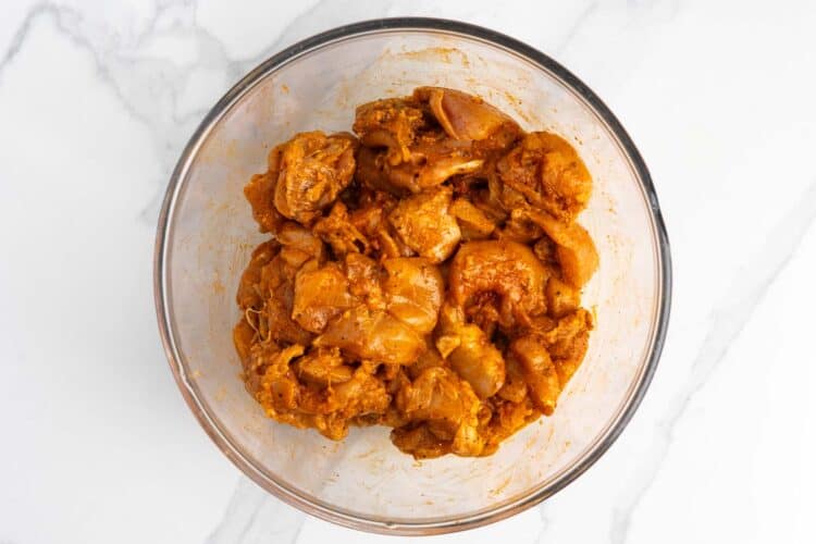 cubes of chicken marinated in spices for halal chicken bowls.