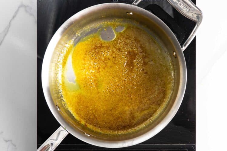 melted butter in a saucepan mixed with turmeric and other spices.